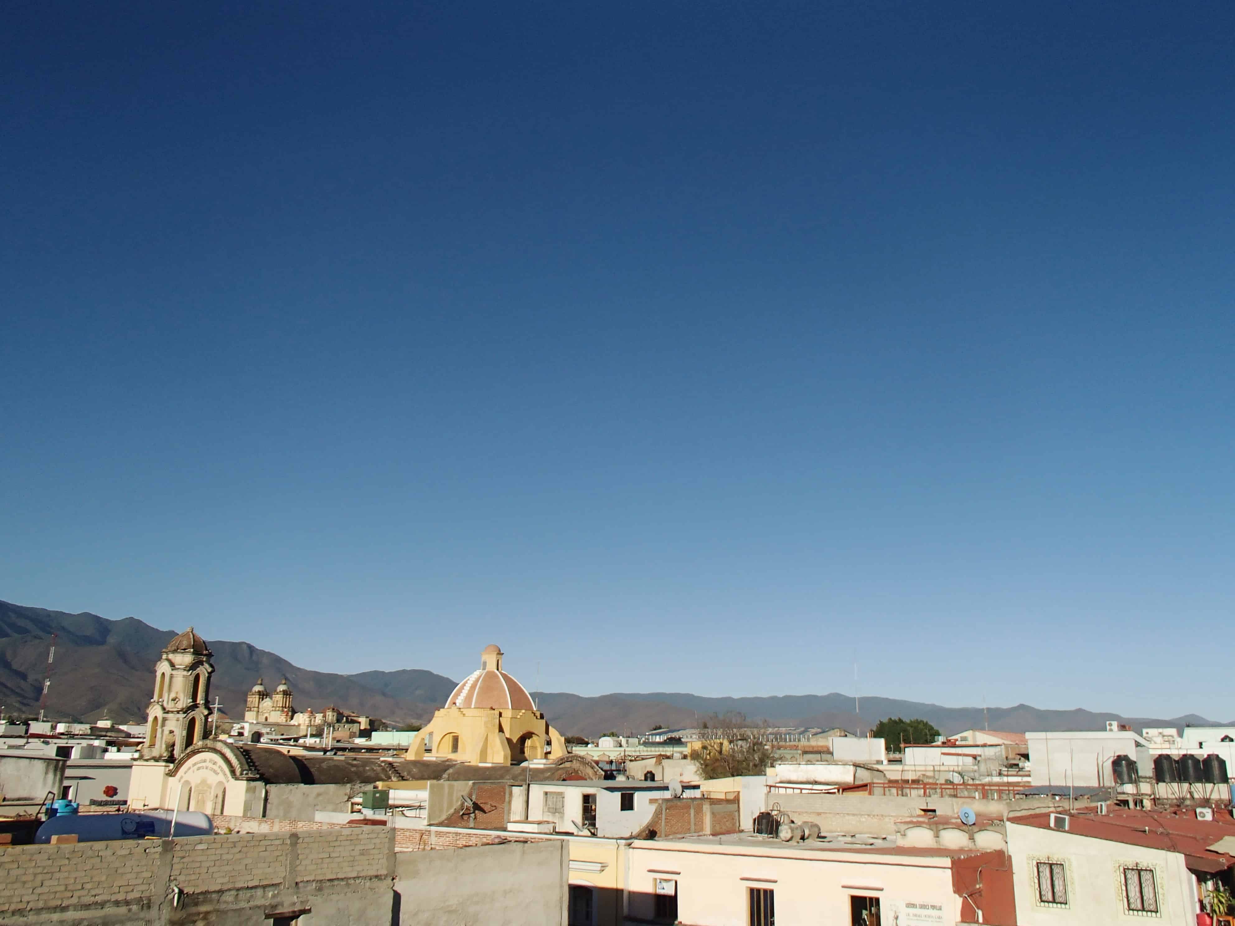 A city view of Oaxaca City, Mexico from our hotel: Parador San Miguel. A charming hotel with an open courtyard, exotic birds, and an amazing restaurant! Only 2 blocks away from the city's central markets and cathedrals. | via Autumn All Along