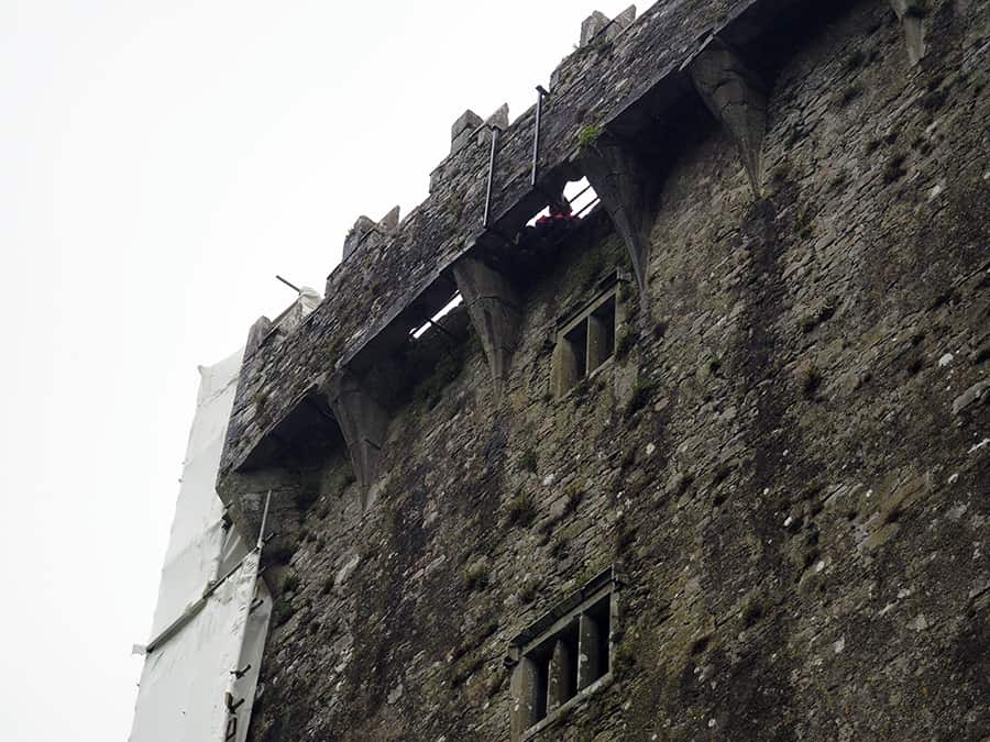 That is the infamous Blarney stone where you can see someone leaning back to kiss the stone. The stone is 90 feet above ground. | via Autumn All Along