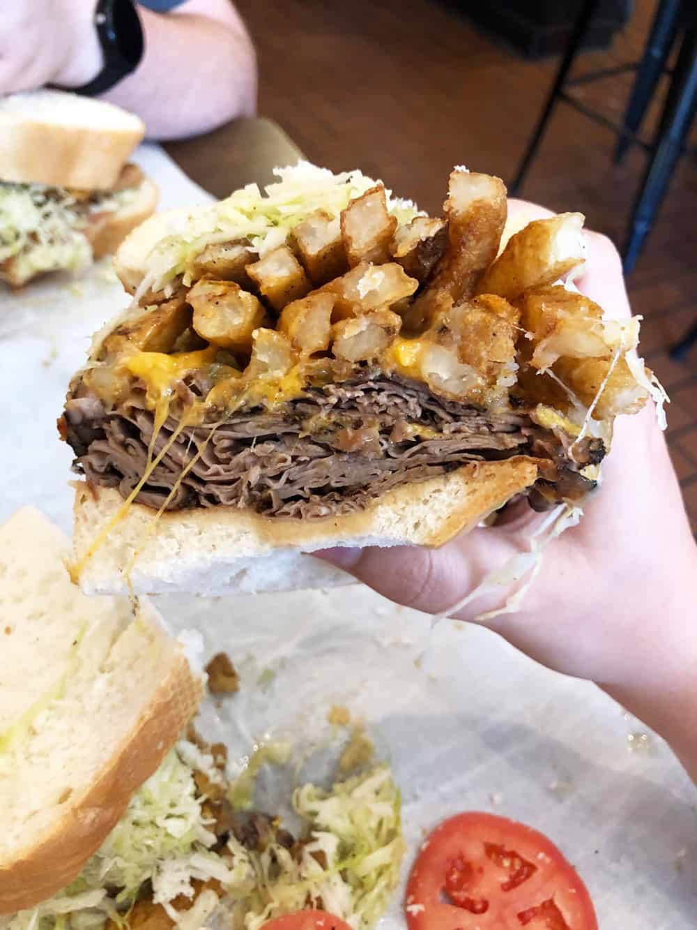 The Primanti Brothers sandiwch includes french fries included. The sandwich and restaurant date back to the Great Depression and the sandwiches were created so workers could take their whole meal without risk of spilling it on themselves. | affordable family day trip + places to visit in Pittsburgh, Pennsylvania via Autumn All Along